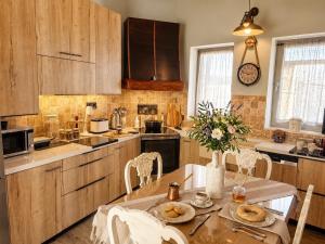 a kitchen with a table with a vase of flowers at Villa Katrinia in Sitia