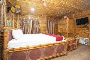 a bedroom with a bed and a flat screen tv at Padmabati Park in Balasore
