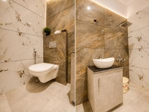 a bathroom with a toilet and a sink at Hotel Atlanta Continental, Paharganj New Delhi in New Delhi
