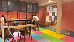 a person standing in a kitchen with a rainbow floor at Joi Boutique Bãi Trước in Vung Tau