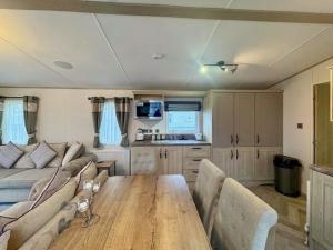 a living room with a table and a couch at Abi Beaumont - Ty Mawr in Rowen