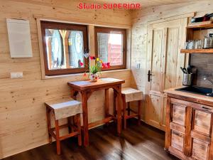 a small kitchen with a wooden table and chairs at MK Apartment Karpaty in Zvončín