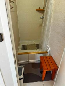 a small shower with a wooden table in a bathroom at Gobi Desert Guesthouse & Tours in Dalandzadgad