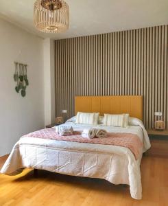 a bedroom with a large bed with towels on it at Ekhiola Txiki in Ochagavía