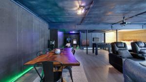a dining room with a wooden table and a couch at Peak Pine by AvantStay in Albrightsville
