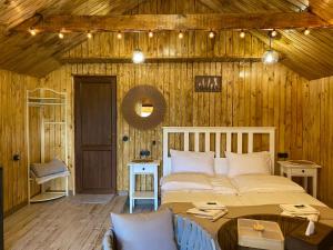 ein Schlafzimmer mit einem großen Bett in einer Holzwand in der Unterkunft Tesaran Stepanavan Guest House, Apart Hotel in Stepanawan