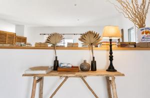 a table with vases and a lamp on it at Villa Riviera in Cala d´Or