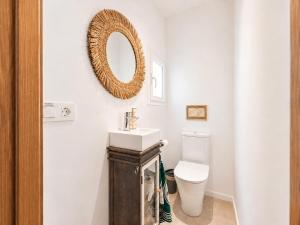 a bathroom with a sink and a toilet at Villa Riviera in Cala d´Or +49 photos