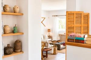 a room with white walls and wooden shelves at Villa Riviera in Cala d´Or
