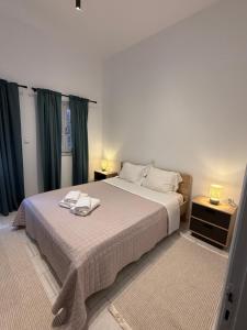 a bedroom with a bed with two towels on it at Anassa Homes Leros in Agia Marina
