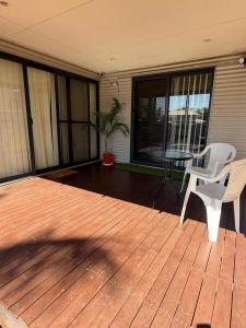 a deck with a table and chairs on a house at Broome Rest House in Broome