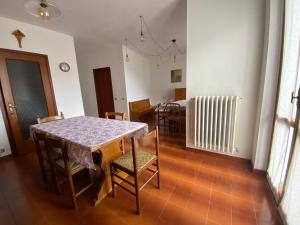 a dining room with a table and chairs at Dormire a Valgoglio Baita della Diga in Valgoglio