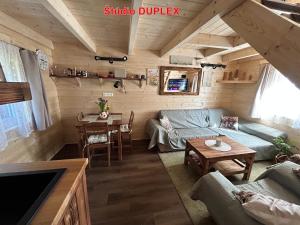 a living room with a couch and a table at MK Apartment Karpaty in Zvončín