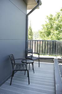 a patio with two chairs and a table on a balcony at Monteva Boutique Hotel in Almaty