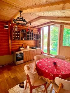 a kitchen with a table and chairs in a room at Vikendica Veruša in Veruša