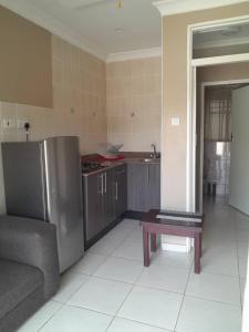 a kitchen with a couch and a table in it at Sky Apartments in Harare