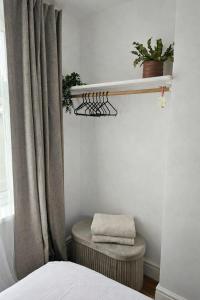 a bedroom with a bed and a shelf and a stool at Cardiff Mini Retreat in Cardiff