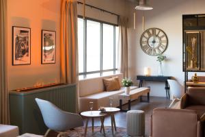 a living room with a couch and a table at Best Western Plus Hôtel de Robien in Saint-Brieuc