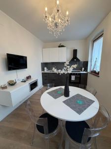 a kitchen with a table and chairs and a chandelier at Sottocastello 1 in Gorizia