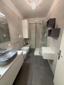 a bathroom with a sink and a shower and a toilet at Sottocastello 1 in Gorizia +20 photos