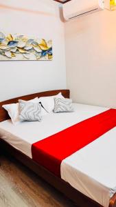 a bedroom with a bed with a red blanket at Wonder Stay in Jaffna +18 photos