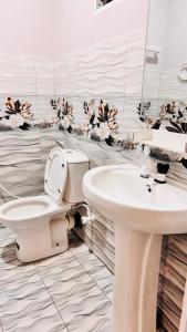 a bathroom with a toilet and a sink at Wonder Stay in Jaffna