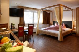 a bedroom with a bed with a canopy at Amontanara in Nauders