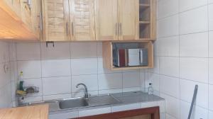 a kitchen with a sink and a microwave at Pati place in Mememo
