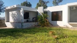 a white house with a lawn in front of it at Pati place in Mememo
