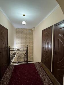 a room with two wooden doors and a bath tub at NUKUS GUEST HOUSE in Nukus