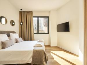 a bedroom with a large bed and a window at Catalina Retiro Madrid in Madrid