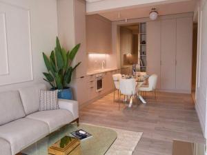 a living room with a couch and a table at Apartament Marreo Casa del Mar in Mamaia