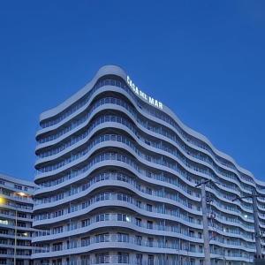 a large office building with a lot of windows at Apartament Marreo Casa del Mar in Mamaia +3 photos