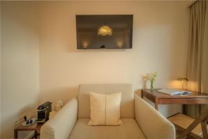 a living room with a couch and a table at Hotel Maroussi in Athens