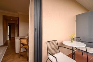 a room with a table and two chairs and a table at Hotel Maroussi in Athens