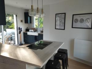 a kitchen with a large counter with stools in it at House in Clamart