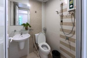 a bathroom with a toilet and a sink and a shower at G8 Le Van Sy Hotel Saigon in Ho Chi Minh City