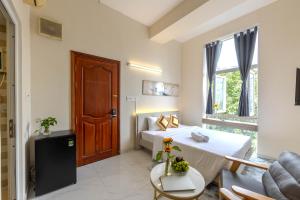 a hotel room with two beds and a window at G8 Le Van Sy Hotel Saigon in Ho Chi Minh City