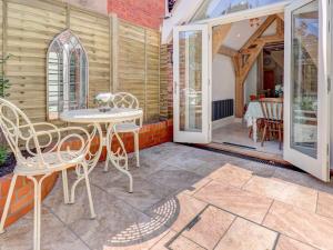 a patio with a table and chairs and a dining room at Bakers View in Winchester