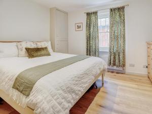 a bedroom with a large bed and a window at Bakers View in Winchester