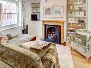 a living room with a fireplace and a couch at Bakers View in Winchester