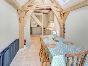 a dining room with a blue table and chairs at Bakers View in Winchester +18 photos
