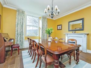 a dining room with a wooden table and chairs at Low Seal House in Richmond