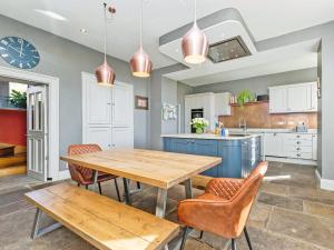 a kitchen with a wooden table and chairs at Low Seal House in Richmond