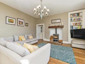a living room with a couch and a fireplace at Low Seal House in Richmond