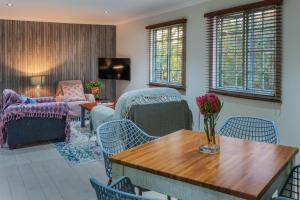 a living room with a table and chairs at Gardenview Sedgefield in Sedgefield