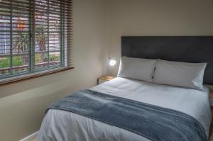 a bedroom with a bed and a window at Gardenview Sedgefield in Sedgefield