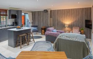 a kitchen and living room with chairs and a table at Gardenview Sedgefield in Sedgefield
