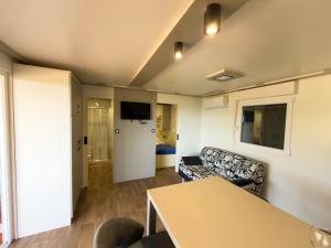 a living room with a couch and a table at Mobile homes Camp Kozica in Sibinj Krmpotski