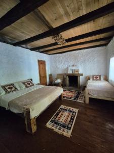 a bedroom with two beds and a fireplace at Norral shelter 1 in Kajvall +17 photos